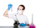 Attentive schoolgirl conducting a chemistry experiment at elementary science class. studying the bacteria through a Royalty Free Stock Photo