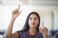 Attentive schoolgirl gesturing in classroom