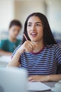 Attentive schoolgirl studying in classroom