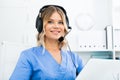 Attentive specialist of medical call center in headphones in office