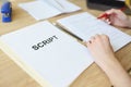 Attentive woman reads script papers editing text with pencil