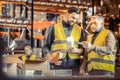 Attentive worker standing in semi position near his coworker