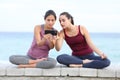 Attentive yogis watching yoga tutorial on phone Royalty Free Stock Photo