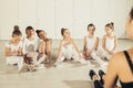 Attentive young ballerinas listen to teacher in studio