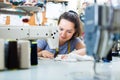 Attentive young professional female tailor using sewing machine Royalty Free Stock Photo