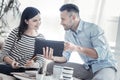 Attentive young woman listening to her colleague Royalty Free Stock Photo