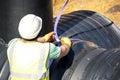 Attenuation tank made of big diameter plastic pipe delivered on construction site, offloaded and moved by an excavator into