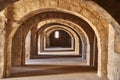 Attic corridors with masonry stone arches in the ancient walls of the Rabbat of Sousse, central perspective