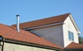 Attic house asphalt shingles roof with metal chimney