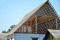 Attic house frame construction. Unfinished roofing with rafters, frame trusses, wooden beams