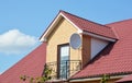 Attic house roofing construction with metal roof and metal balcony