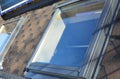 Attic skylight roof windows on the asphalt shingles house roof. Royalty Free Stock Photo
