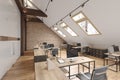Attic office open space with beams, glass doors, brick wall, wooden floor, furniture and computers. Royalty Free Stock Photo