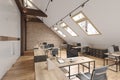 Attic office open space with beams, glass doors, brick wall, wooden floor, furniture and computers.