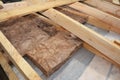 Attic Roof Insulation. Close up on insulation layers of mineral wool insulation, house roof insulation. Insulating with Mineral