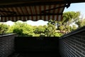 Attic terrace with exposed tiles of a single-family home with gloss dark brown stoneware flooring, matching retractable awning and