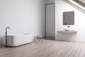 Attic white bathroom corner with sink and tub Royalty Free Stock Photo