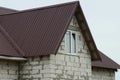 Attic of a white brick house with one window Royalty Free Stock Photo