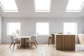 Attic white kitchen with bar and table, side view Royalty Free Stock Photo