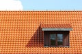 Attic window in orange tiled roof Royalty Free Stock Photo