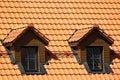 Attic window in orange tiled roof Royalty Free Stock Photo