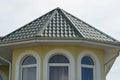 Attic of a yellow house with white windows Royalty Free Stock Photo