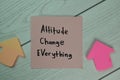Attitude Change Everything write on sticky notes isolated on Wooden Table