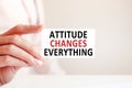 Attitude changes everything written on a paper card in woman hand