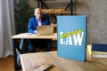 Attorney holds ARIZONA LAW book. Arizona residents are subject to Arizona state and U.S. federal laws