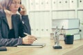 Attorney woman talking on mobile phone from her office desk Royalty Free Stock Photo