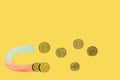 Attract money, euro coins are a magnet. Yellow background, free space for text