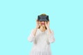 Attracting a young woman in a white blouse with a VR headdress, a shocking look of panic on isolates screen