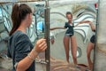 Attraction, girl looking at her image in the distorted mirror in the hall of mirrors Royalty Free Stock Photo