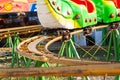 Attraction type roller coaster near the caterpillar . Royalty Free Stock Photo