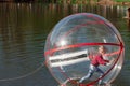 Attraction on the water, ZORB, the boy in a bowl on the water. Water attractions, rest, vacation, vacation