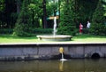 Attractions of the Peterhof Museum-reserve.Small round fountains are installed along the `Sea channel`.