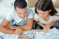 attractive adult couple looking at house plans Royalty Free Stock Photo