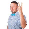 Attractive adult man with beard in a blue bow tie in summer shirt shows the gesture with hands on an isolated white background