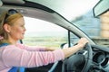 Attractive adult woman safe carefully driving car suburban road