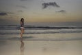 Attractive african american black woman walking on sunset beach Royalty Free Stock Photo