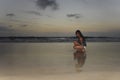 Attractive african american black woman walking on sunset beach Royalty Free Stock Photo