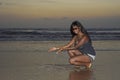 Attractive african american black woman walking on sunset beach enjoying water and sand relaxed Royalty Free Stock Photo