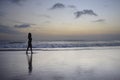 Attractive african american black woman walking on sunset beach enjoying water and sand relaxed Royalty Free Stock Photo