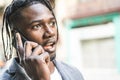 Attractive African American Guy portrait talking on mobile phone on the street