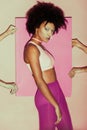 attractive african american 80s model in pink clothes posing with pink Royalty Free Stock Photo