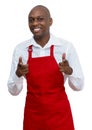 Attractive african american waiter with red apron Royalty Free Stock Photo