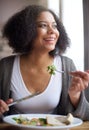 Attractive african american woman eating salad at home Royalty Free Stock Photo