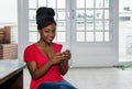 Attractive african american woman sending message with phone Royalty Free Stock Photo