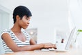 Attractive african businesswoman working with laptop and drinking coffee Royalty Free Stock Photo