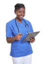 Attractive african nurse working with tablet computer Royalty Free Stock Photo